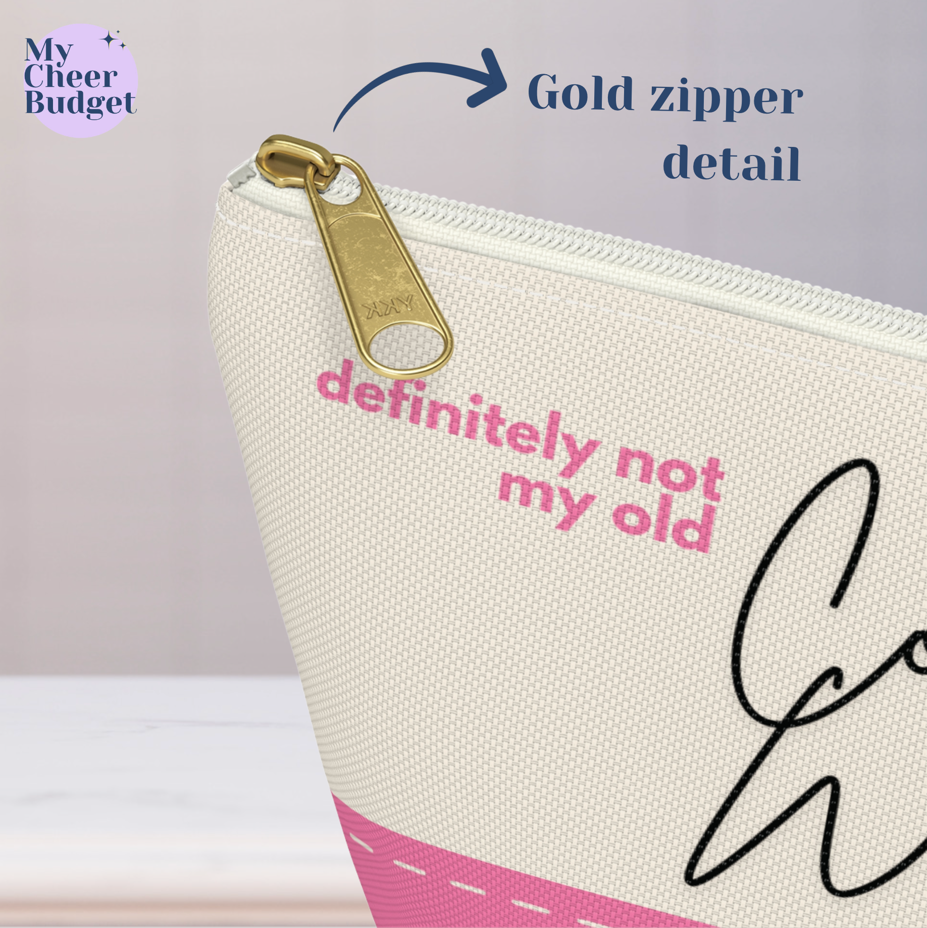 Small zippered pouch bag for cheer moms, cream color printed with "definitely not my old comp wristbands" in pink and black accents