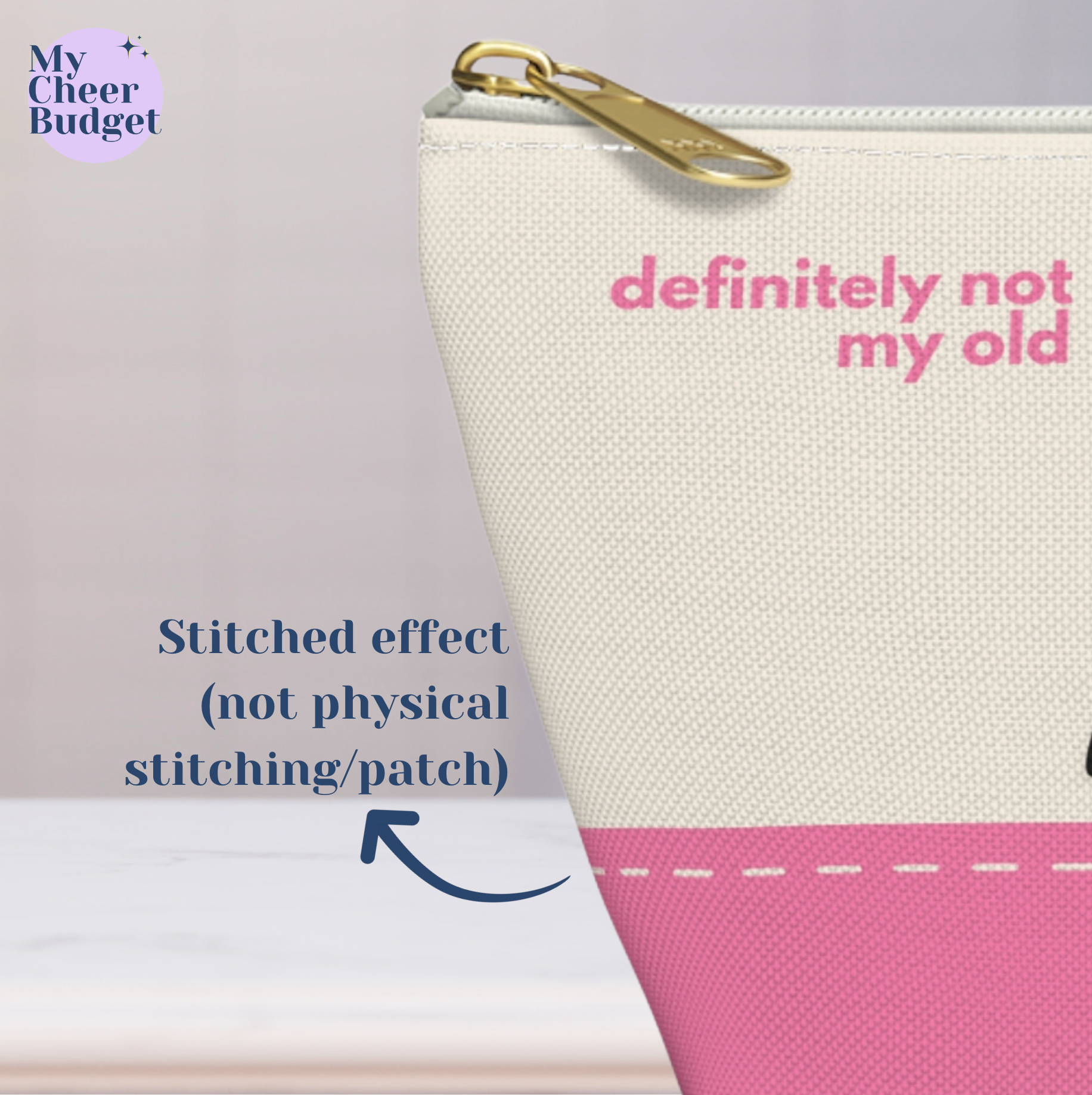 Small zippered pouch bag for cheer moms, cream color printed with "definitely not my old comp wristbands" in pink and black accents