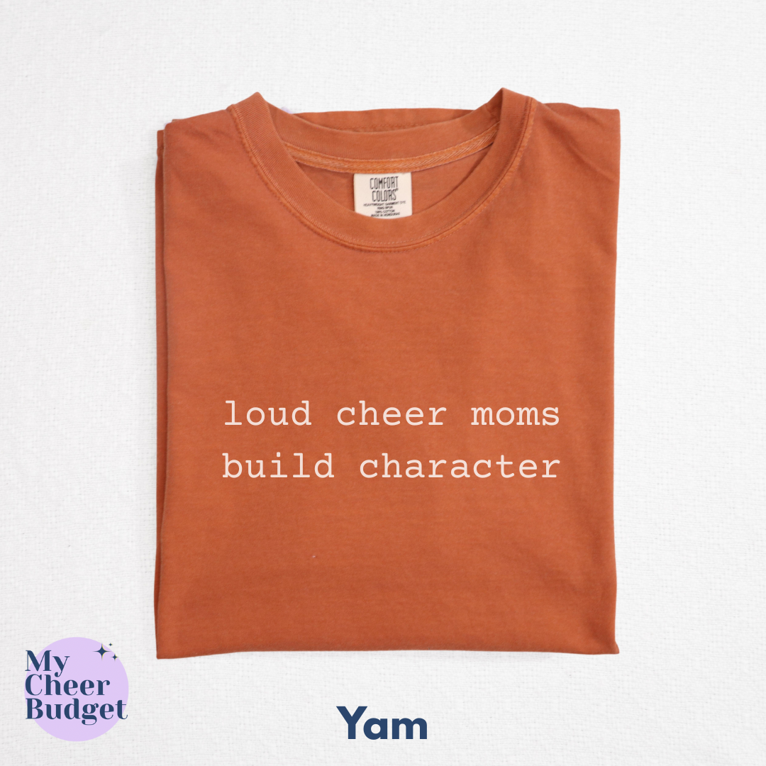 orange t-shirt with white text 'loud cheer moms build character'