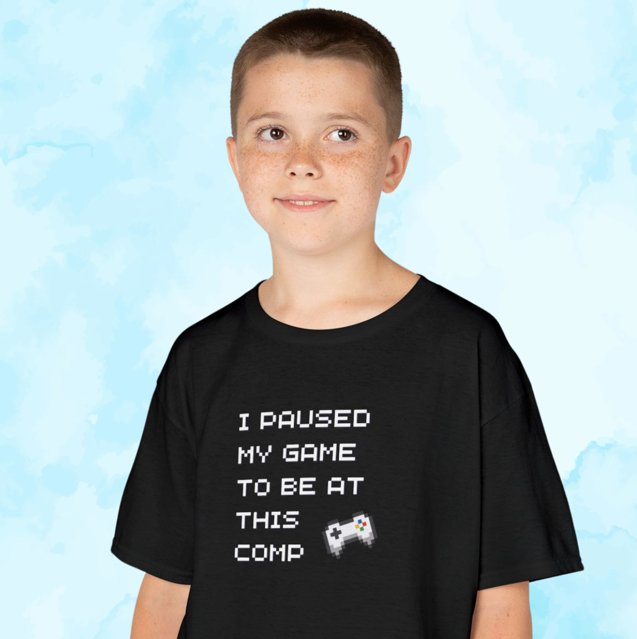 Boy in Gildan youth t-shirt with I Paused My Game to Be at This Comp print for supporting cheer sister