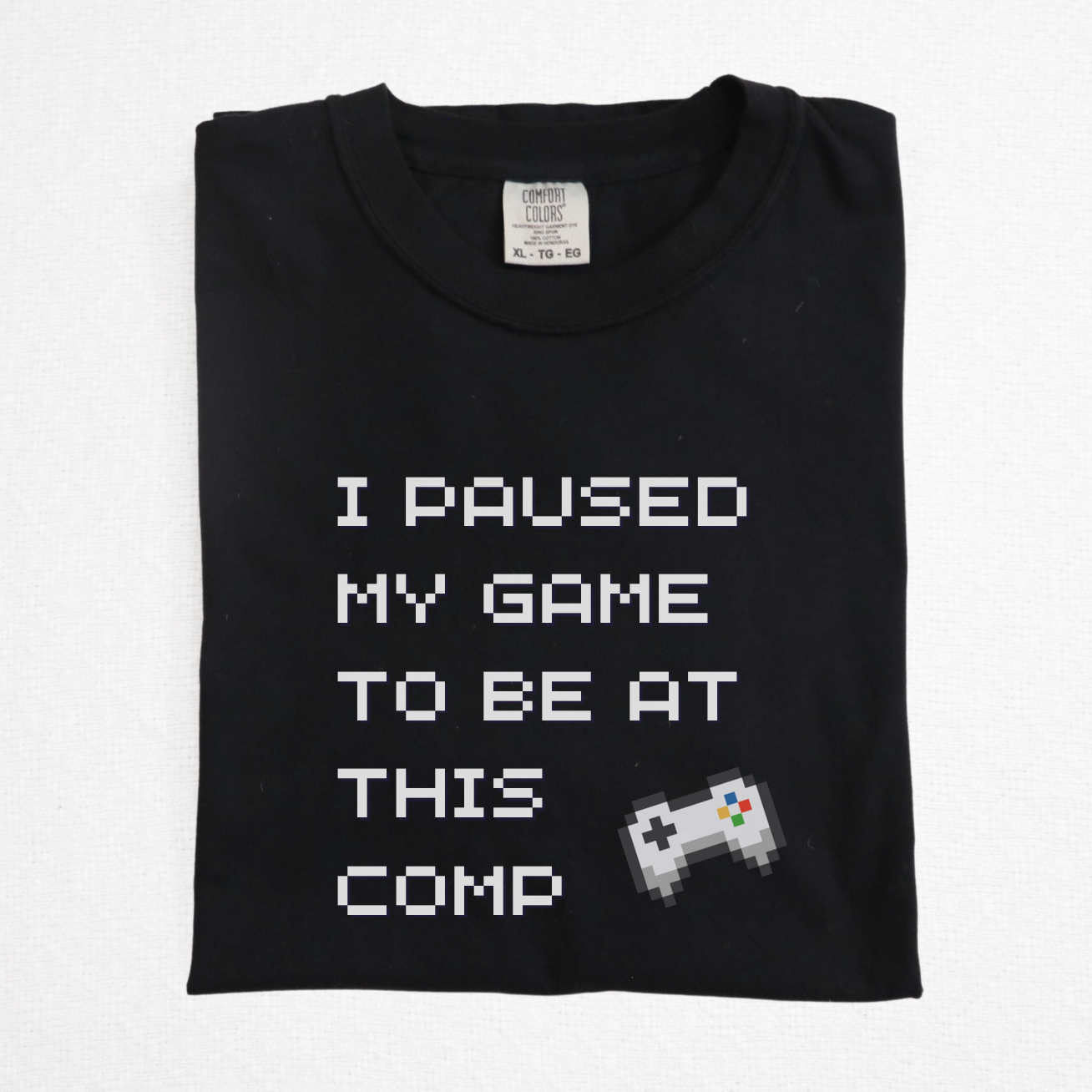 Close-up of retro 8-bit style text and video game controller on gamer cheer shirt for dads and brothers
