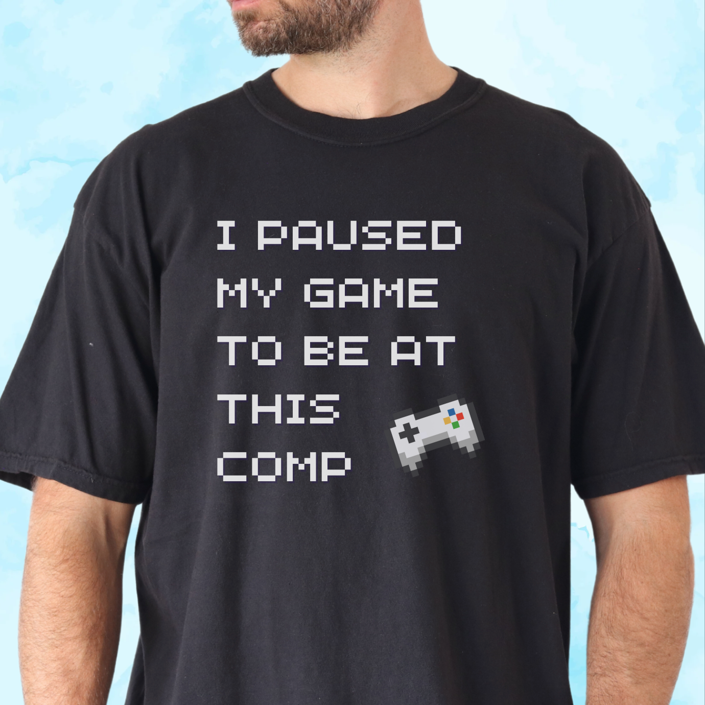 Adult t-shirt with I Paused My Game to Be at This Comp text in 8-bit font and video game controller graphic